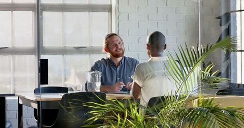 Diverse professionals engaging in corporate discussion at office