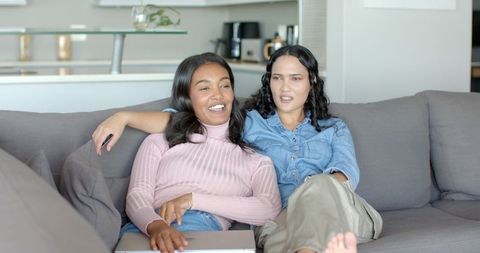 Diverse Female Friends Relaxing Together in Modern Living Room