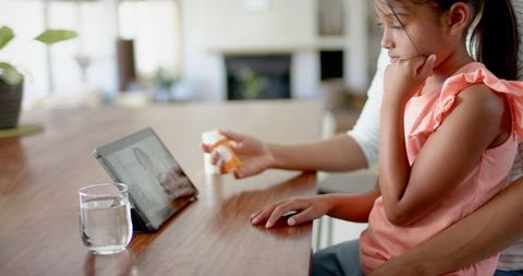 Mother and daughter online consultation with doctor at home