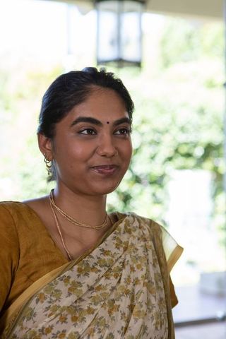 Elegant indian woman in traditional sari on veranda