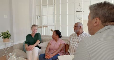 Seniors Having Thoughtful Discussion in Bright Living Room