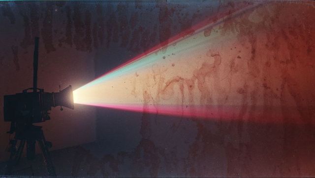 Vintage Film Projector Casting Multicolored Light Beam