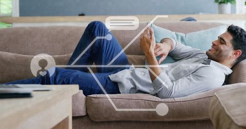 Relaxed Man Using Tablet on Couch in Cozy Living Room