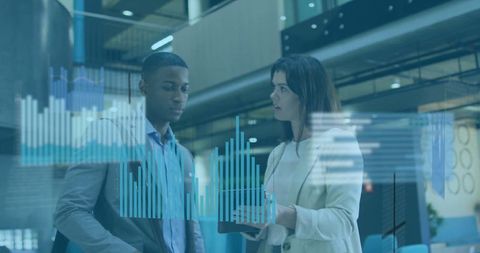 Colleagues Discussing Holographic Bar Graphs in Modern Office Atrium