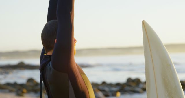 Surfer Stretching Before Riding Ocean Waves in Morning Light - Download Free Stock Images Pikwizard.com