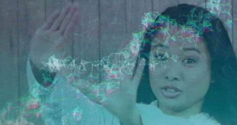 Asian Woman Interacting with Vibrant Holographic Network