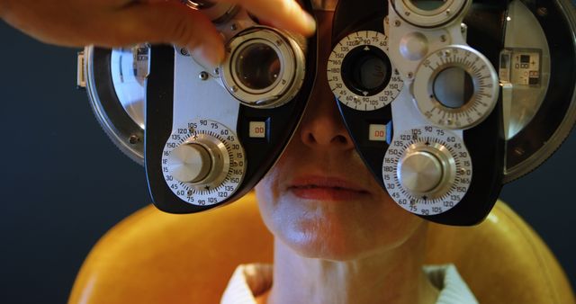 Woman undergoing eye exam with phoropter - Download Free Stock Images Pikwizard.com