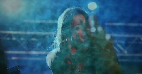 Electric Stage Ambiance with Energetic Female Vocalist