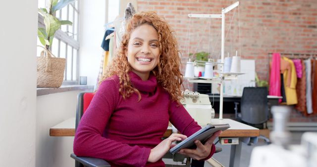 Smiling Fashion Designer with Tablet in Creative Workspace - Download Free Stock Images Pikwizard.com