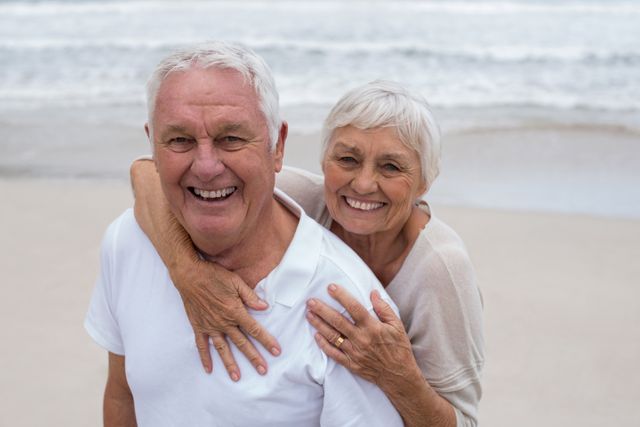 Portrait of senior couple embracing each other on the beach