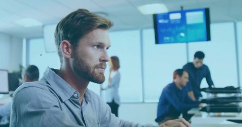 Focused Professional Typing on Computer at Modern Office