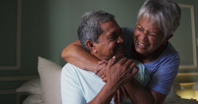 Happy Senior Couple Embracing in Cozy Bedroom - Download Free Stock Images Pikwizard.com