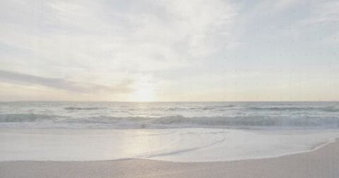 Serene Ocean Waves at Sunset with Pastel Skies