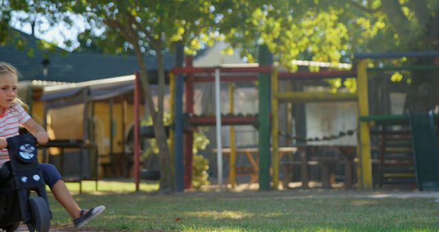 Child Playing on Bike in Park with Play Structures in Background - Download Free Stock Images Pikwizard.com