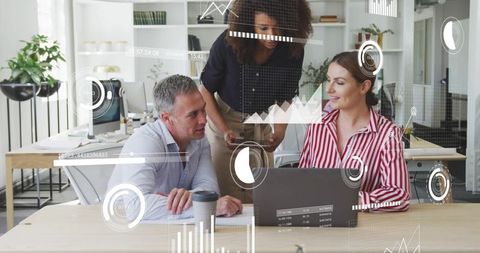 Diverse business team analyzing data with laptop in casual office