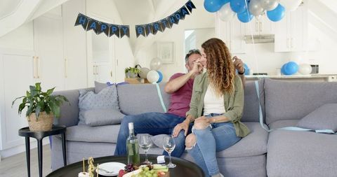 Happy Couple Enjoying Birthday Party in Cozy Living Room Setting