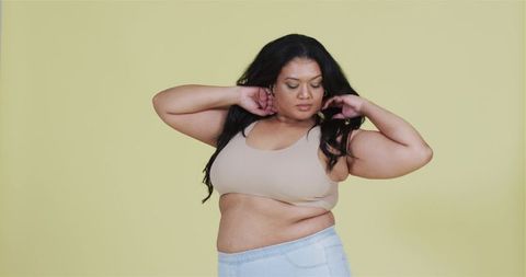 Confident Plus Size Woman Posing in Minimalist Fashion