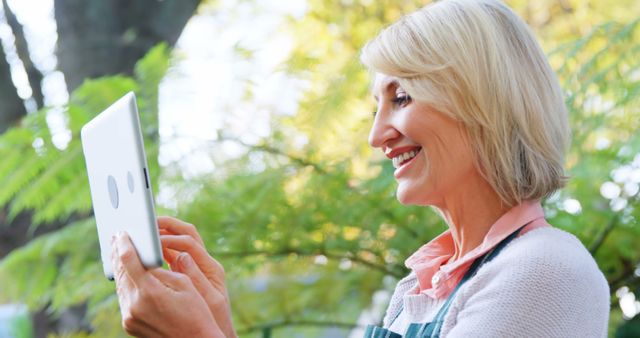 Senior Woman Smiling and Video Calling on Tablet in Garden - Download Free Stock Images Pikwizard.com