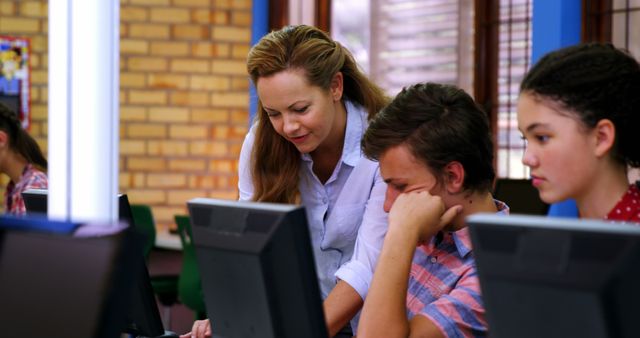 Teacher Assisting Students in Classroom with Computers - Download Free Stock Images Pikwizard.com