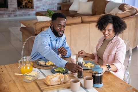 Happy Couple Sharing Breakfast with Coffee in Cozy Home Setting