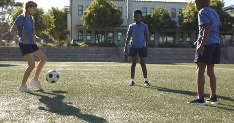 Sunlit youth soccer practice on synthetic turf showcasing teamwork and diverse players