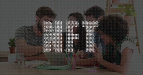 Creative workers collaborating around laptop for innovative project