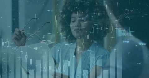 Business Analyst Evaluating Data with Financial Graphs Overlay