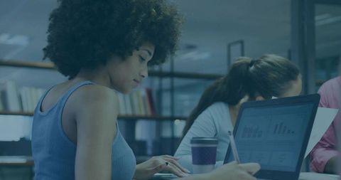 Focused Woman Working in Modern Office With Laptop and Coffee