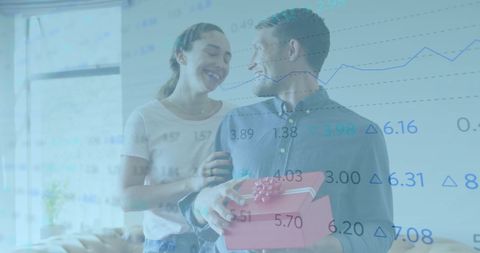 Happy Couple Exchanging Gifts with Stock Market Overlay