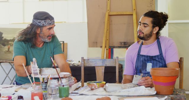 Artists Discussing Pottery While Working in Studio - Download Free Stock Images Pikwizard.com