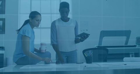 Creative designers discussing project plans in modern office