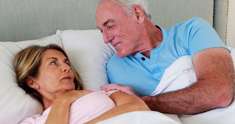 Senior Couple Sharing Moments on Cozy Bed
