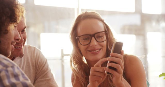 Friends Laughing Together Using Smartphone Indoors - Download Free Stock Images Pikwizard.com