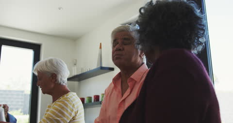 Diverse Seniors Enjoying Meal in Bright Gathering Room