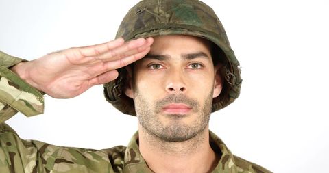 Young soldier saluting in military uniform on white background