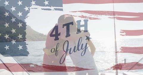 Fourth of July celebration by the sea with couple embracing