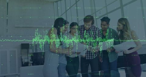 Team analyzing financial data through digital interface in office