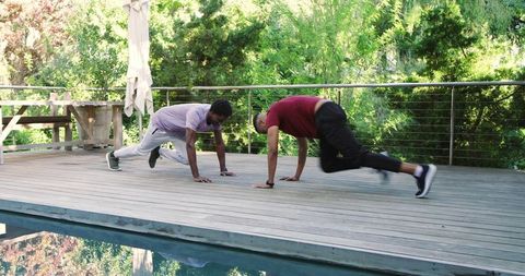 Diverse Friends Doing Mountain Climbers on Outdoor Deck