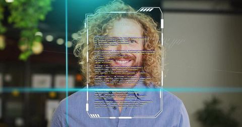 Smiling professional with curly hair viewed through code overlay
