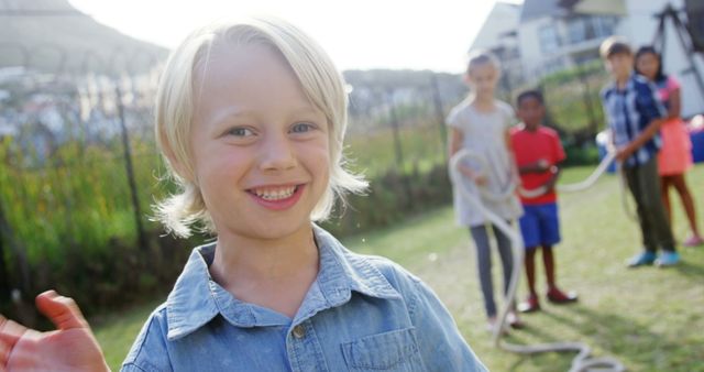 Smiling Boy Playing Outdoors with Friends on a Sunny Day - Download Free Stock Images Pikwizard.com