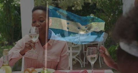 Family Relaxing in Outdoor Patio with Honduran Flag Overlay