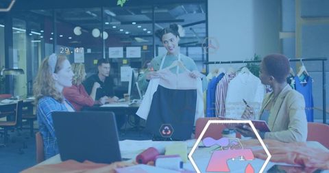 Designer presenting dress to team in modern studio for fashion design collaboration