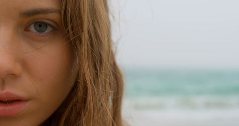 Close-up of Woman by the Sea with Soulful Gaze - Download Free Stock Images Pikwizard.com