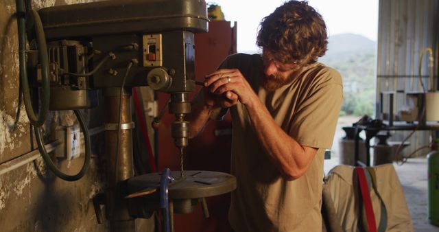 Focused Artisan Using Industrial Drill Press In Workshop - Download Free Stock Images Pikwizard.com