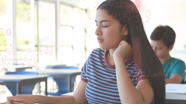 A Hispanic girl deeply focused on her studying with math formulas superimposed in the air. Ideal for articles and blogs discussing education methods, math skills in students, or innovative classroom environments. Great visual for academic posters, educational websites, and e-learning platforms advertising their courses or tools.