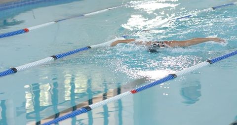 Professional Swimmer Performing Freestyle Stroke in Goeswimming Up Pool Lane - Download Free Stock Images Pikwizard.com