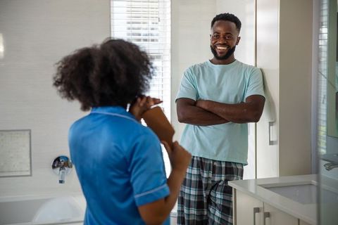 Couple enjoying morning routine in modern bathroom