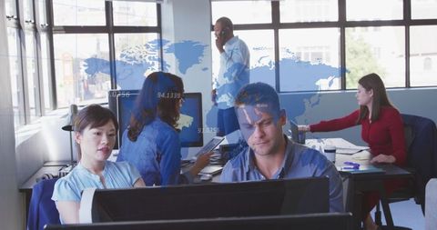 Diverse business team collaborating with data overlay in modern office
