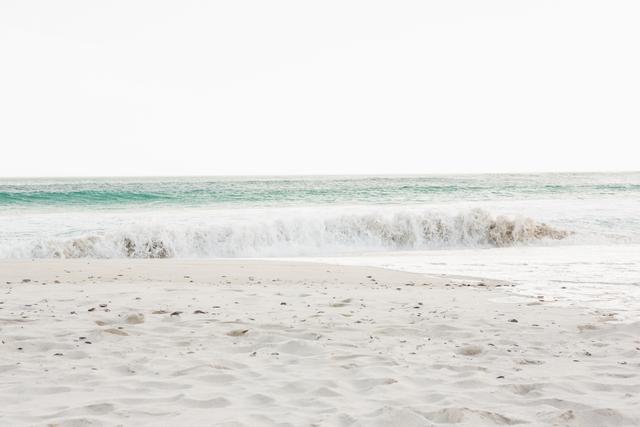 Sandy Beach with Rolling Waves on Serene Shore - Download Free Stock Images Pikwizard.com