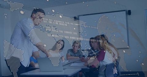 Instructor guiding students around laptop with digital world map overlay for learning